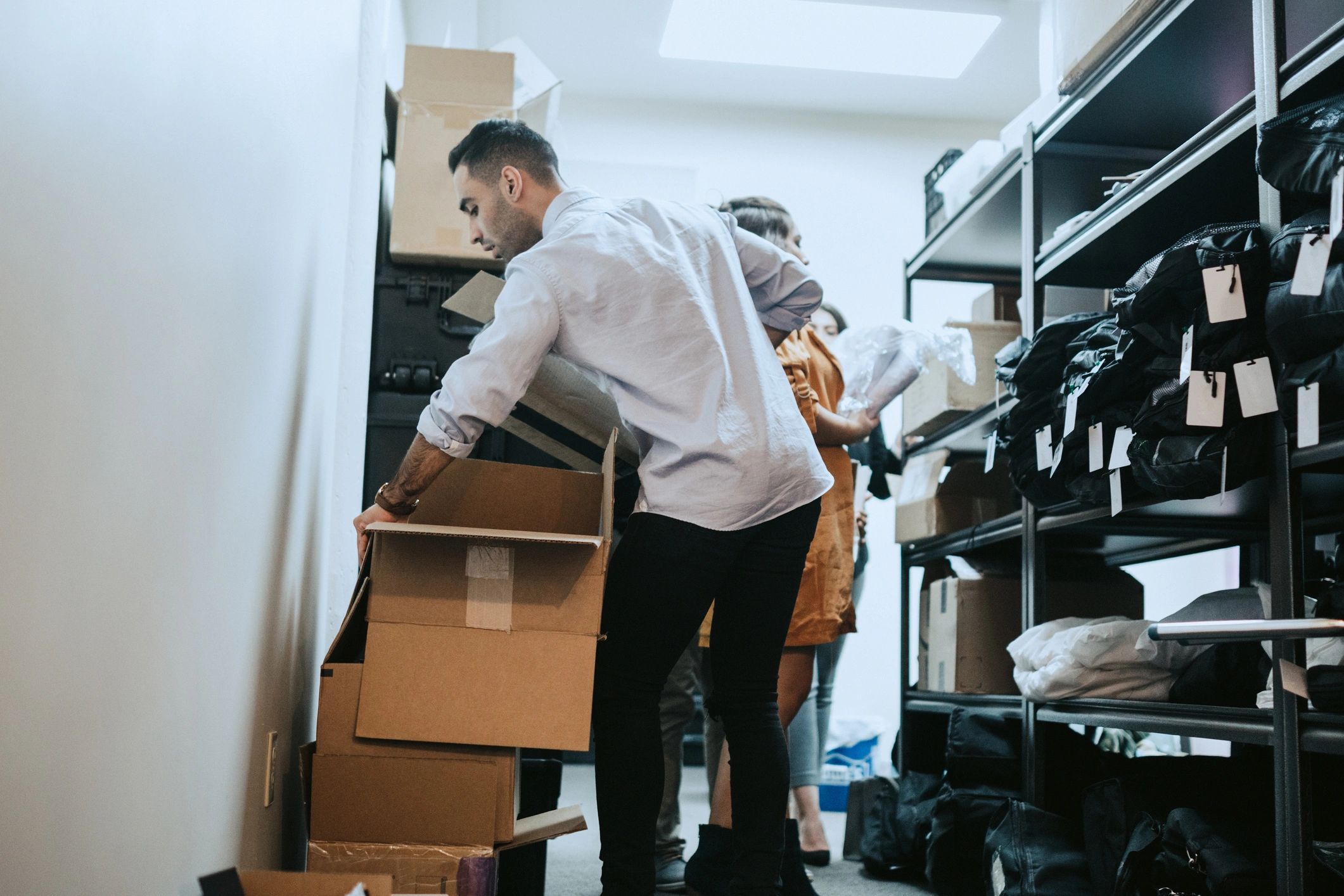 Team preparing items for transport in a warehouse setting