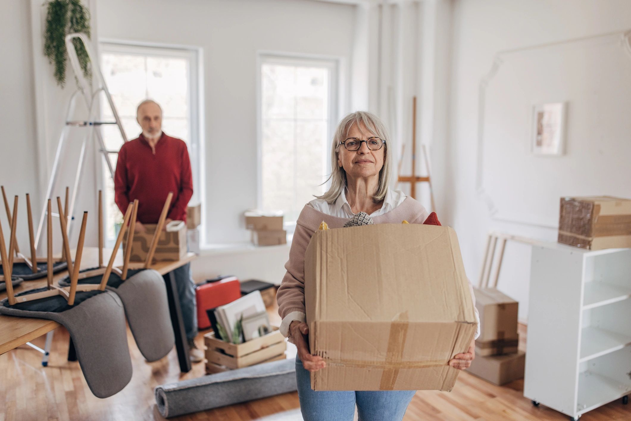 Couple unpacking boxes in their new home after a move
