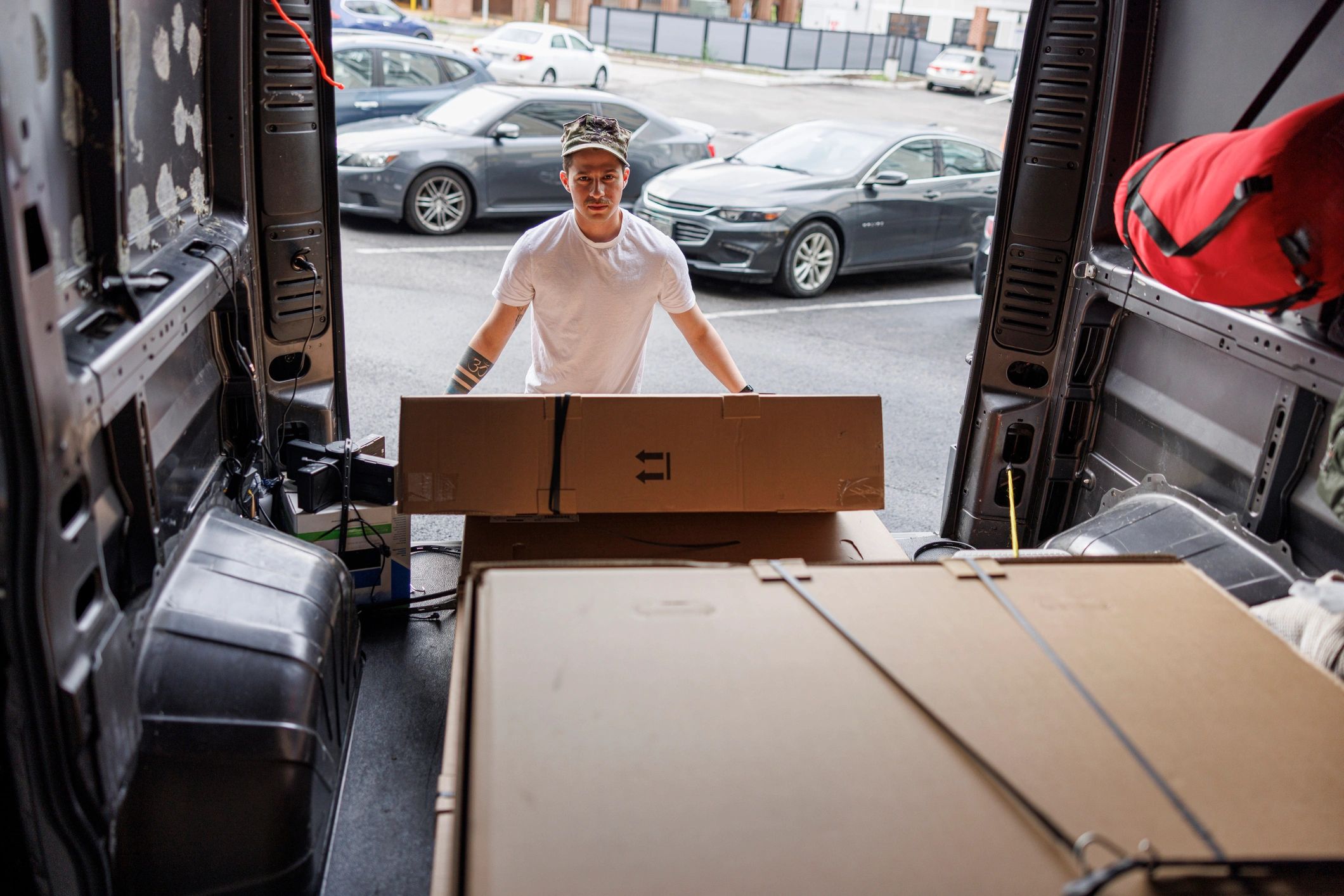 Person unloading boxes from a van