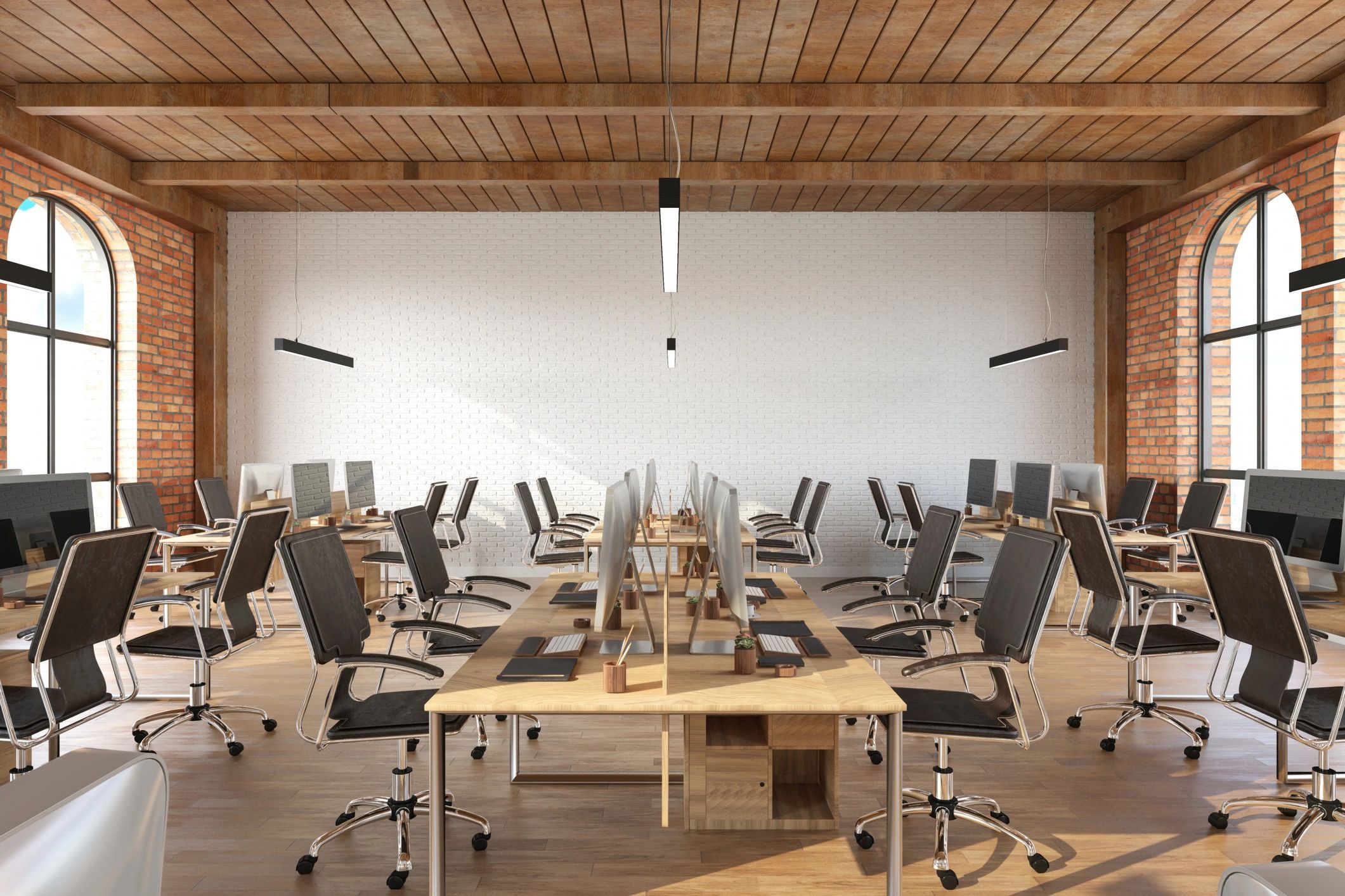 Open plan office with desks and computer screens